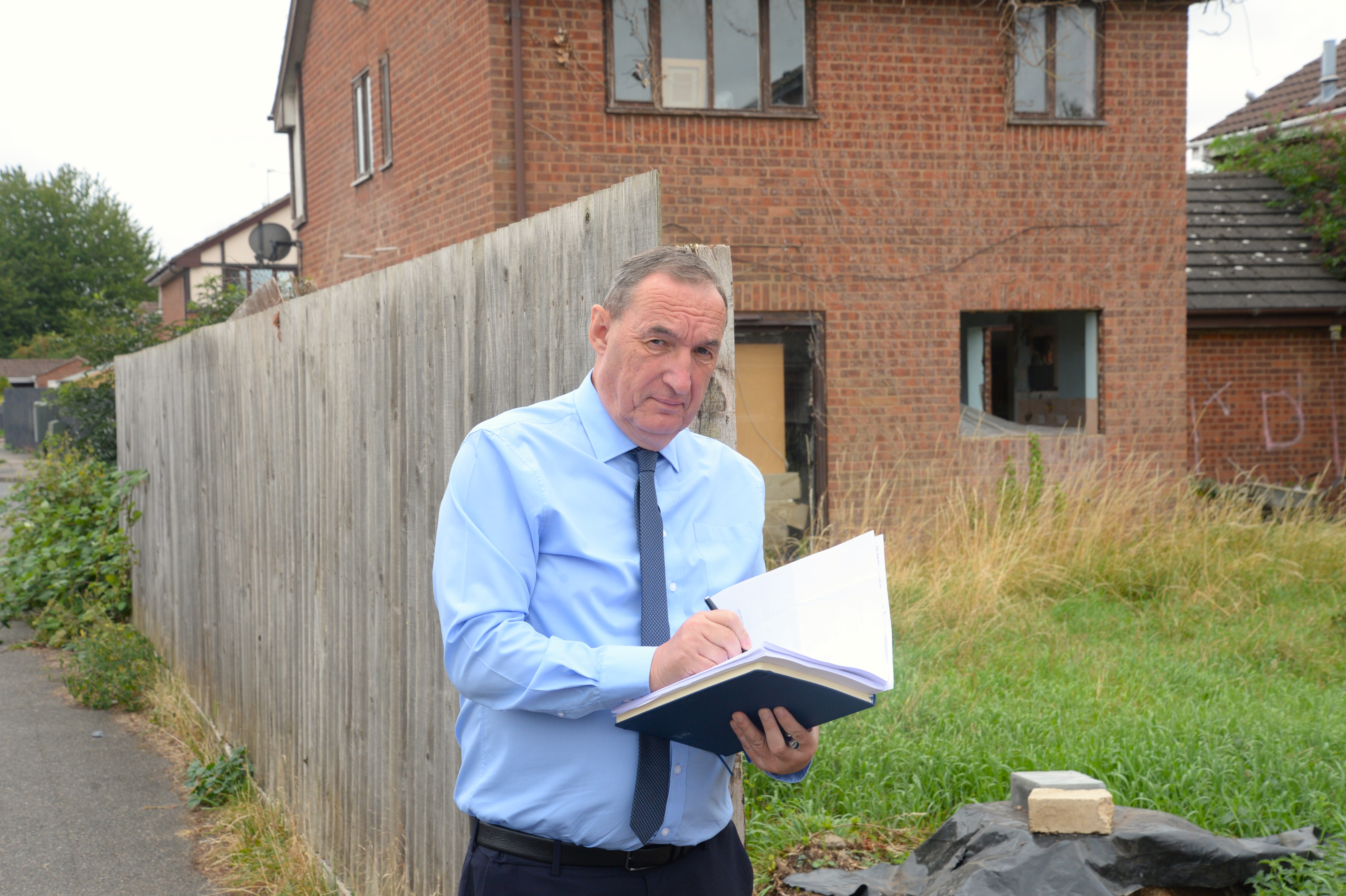 SKDC’s Empty Homes Project Officer Peter Harrison is pictured outside a derelict property the council is considering taking enforcement action on as the owner has yet to engage and it has been left insecure and open to the elements.