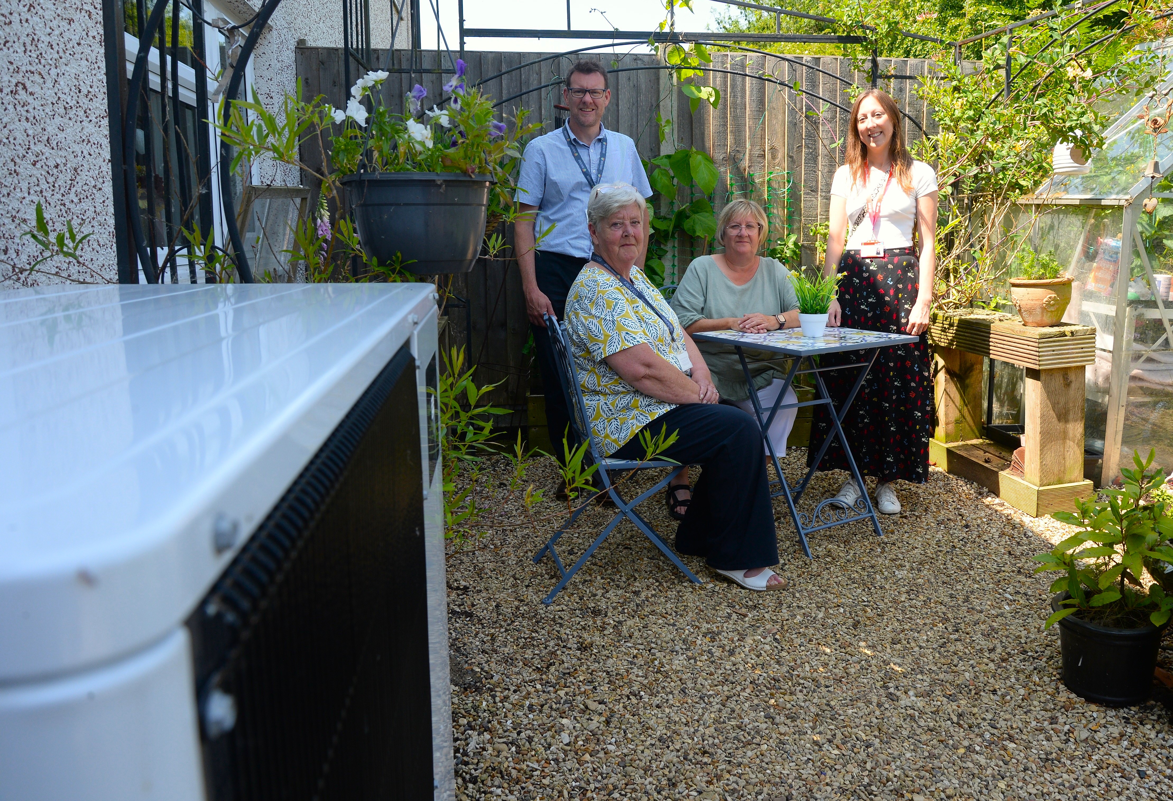 SKDC’s Head of Technical Services, Mark Rogers, Cabinet Member for Housing Virginia Moran, tenant Debi Palmer and E.ON Project Administrator Claire Huzar. Debi has had an air source heat pump (left) fitted
